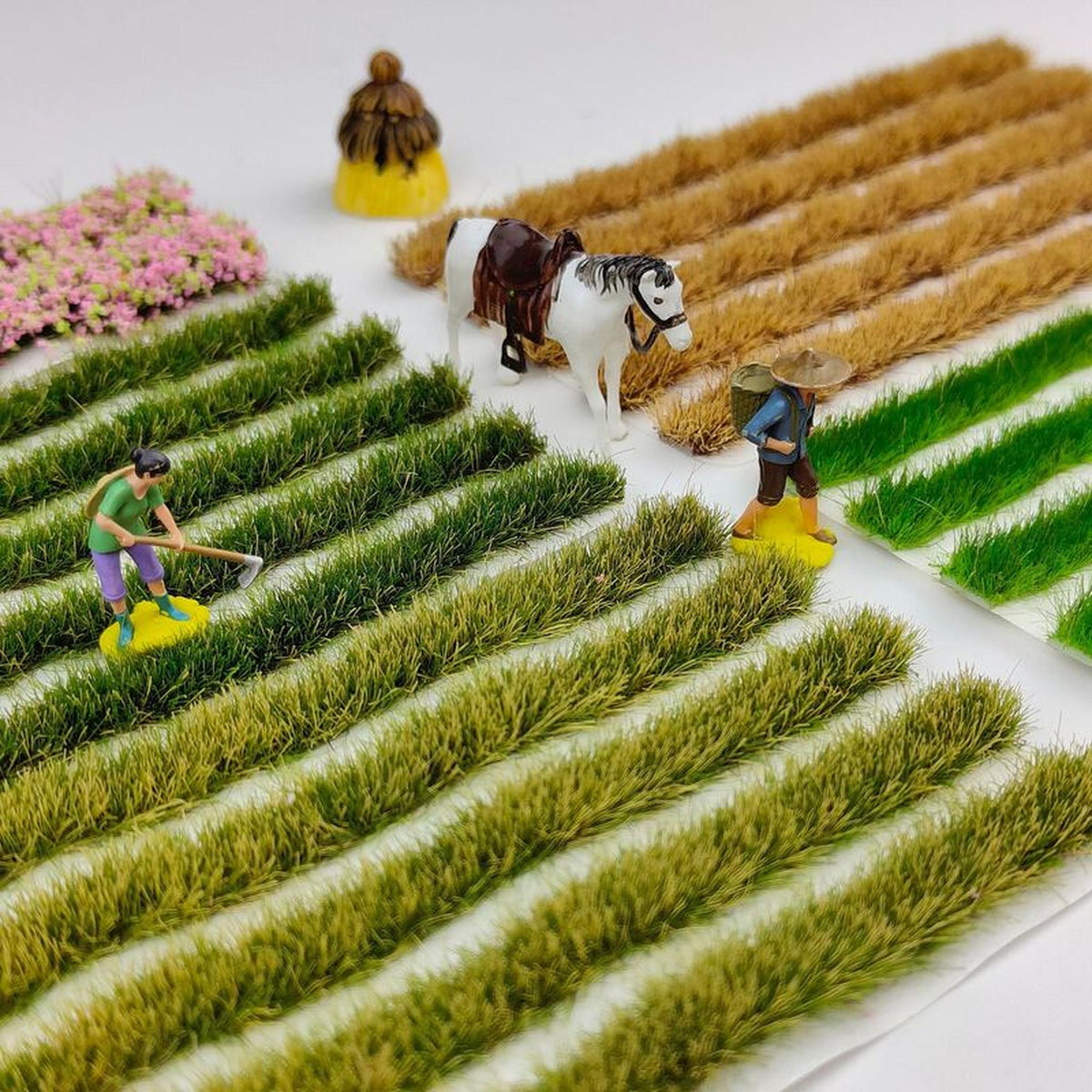 Strip grass tufts laid as farmland rows on a model field diorama - Wargame Base World