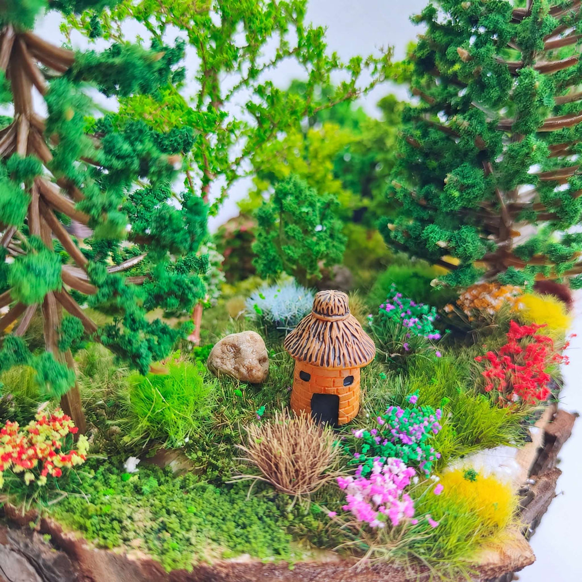 Thatched cottage garden scene with flower clusters - Wargame Base World