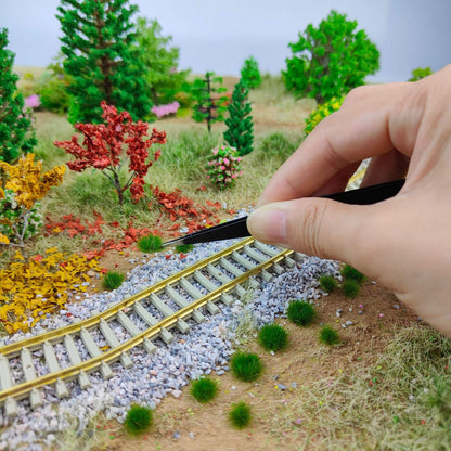 Peeling 5mm grass tufts off the backing film with tweezers - Wargame Base World