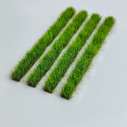 Four green 8mm strip grass tufts on white background - Wargame Base World