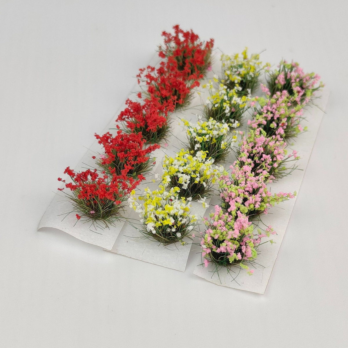 Miniature figures in flower-filled garden scene - Wargame Base World